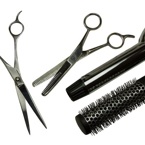 Scissors, hair shears, curling iron and styling brush