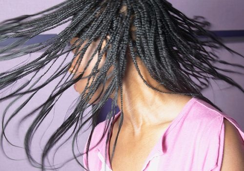 Woman swinging her long braids 2