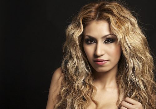 Woman with blond curly wavy hair created with waving iron