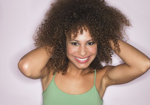Woman with hands in her curly hair 2