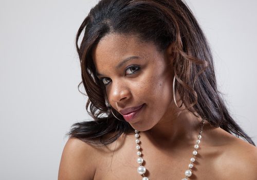 woman smiling with pearls