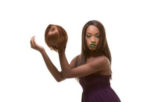 Woman with wig in hand